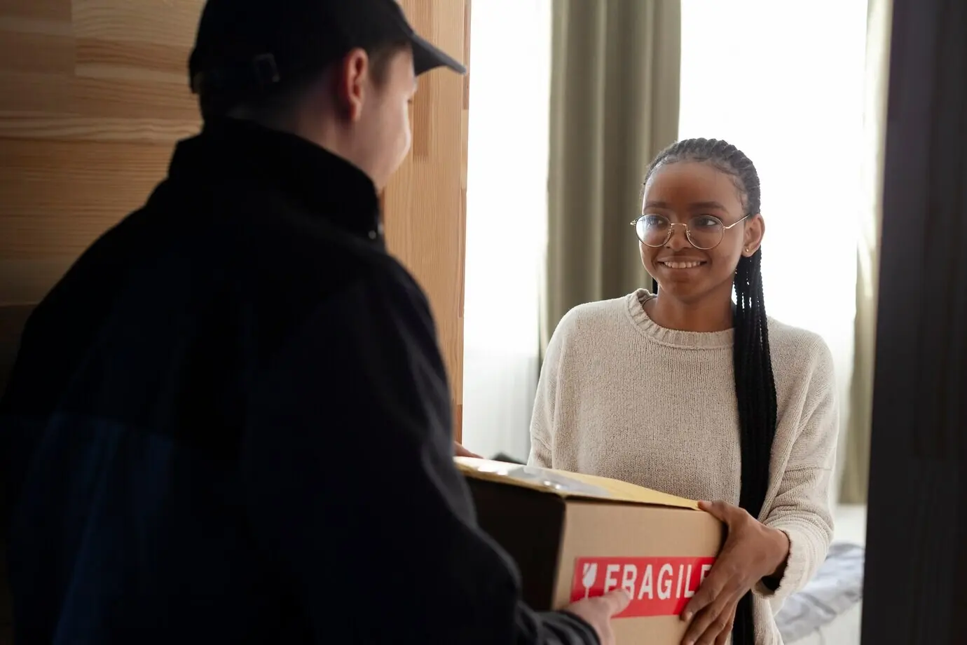 Курьер передаёт клиенту посылку